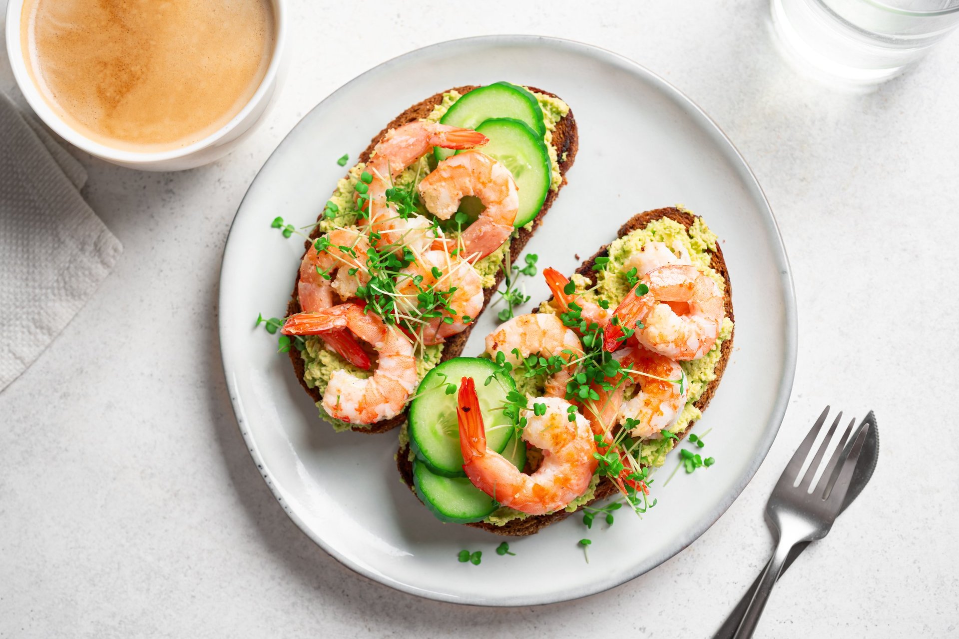 Avocado shrimp sandwiches with microgreens close up